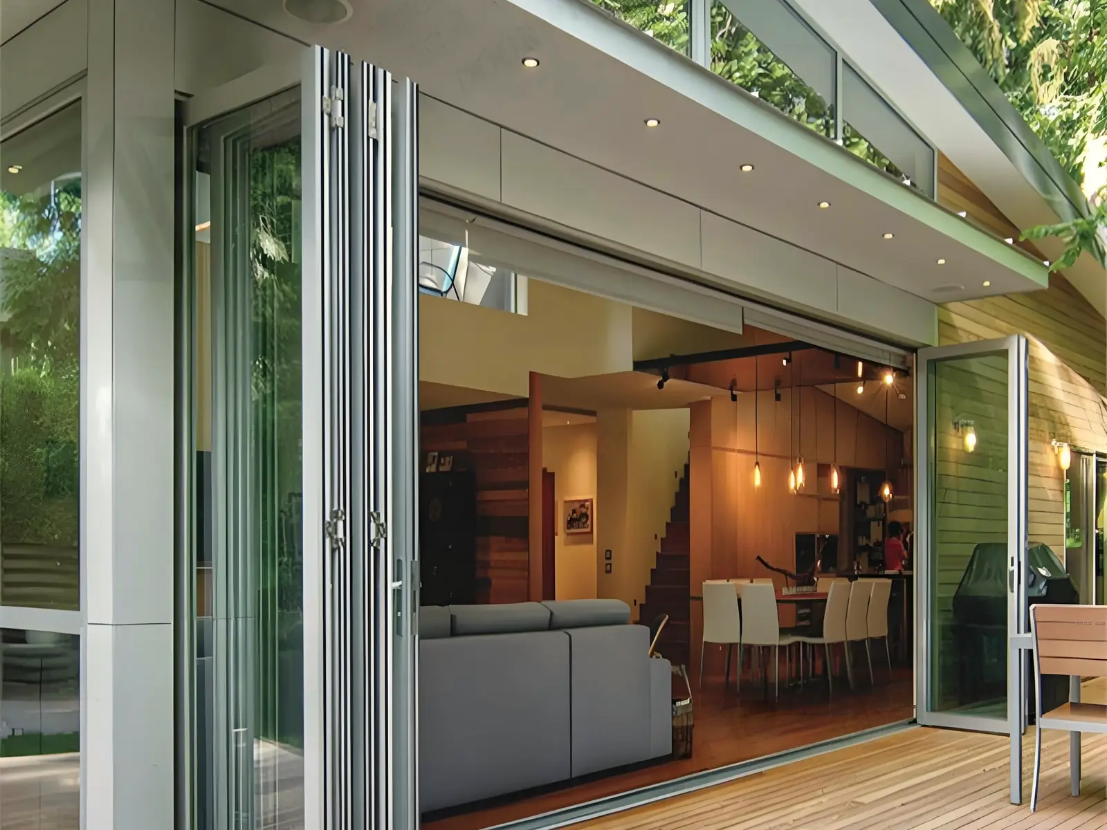 A finished extension with folding glass doors open onto a timber deck
